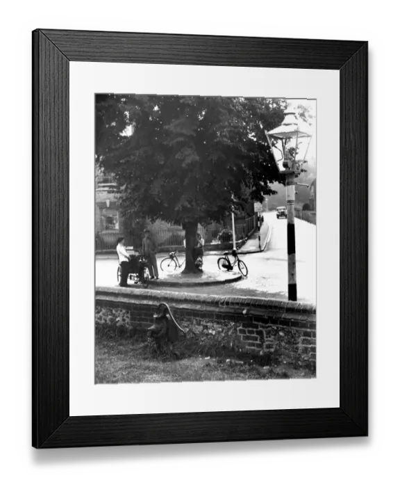 Framed Print : Looking from the churchyard at the roundabout and down the road at the village of Downe