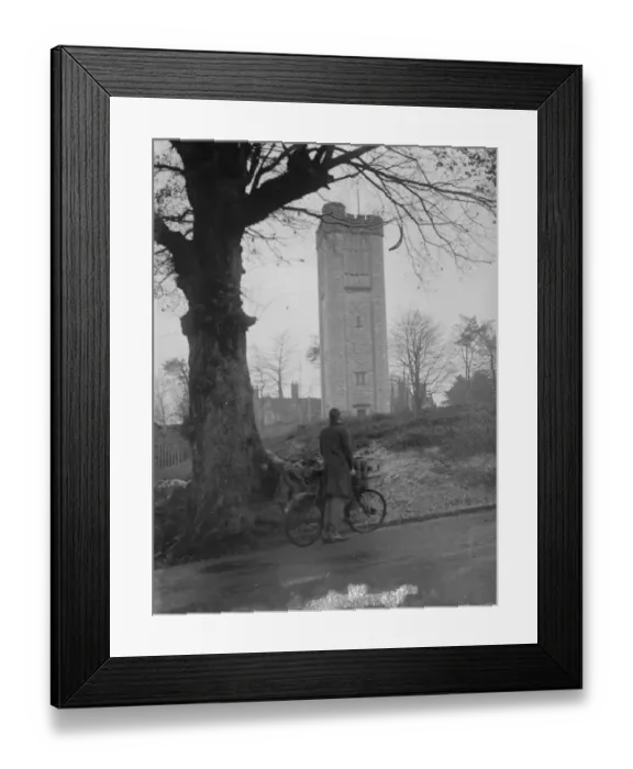 Framed Print : Cyclist looks at a water tower. 1935