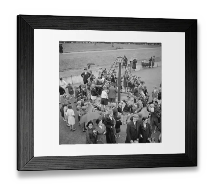 Framed Print : Children playing on the top hat roundabout at the childrens playground in Crayford Framed Print : Children playing on the top hat roundabout at the childrens playground in Crayford