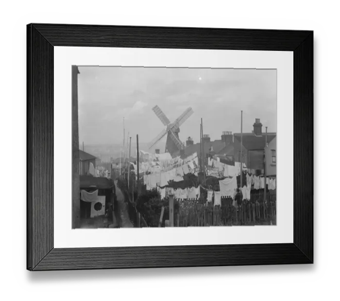Framed Print : Rochester windmill in Kent, seen from behind the washing lines. 1936 Framed Print : Rochester windmill in Kent, seen from behind the washing lines. 1936