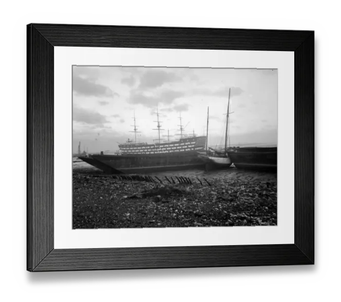 Framed Print : Shipping run aground on the shore in front of HMS Worcester on the River Thames off Framed Print : Shipping run aground on the shore in front of HMS Worcester on the River Thames off