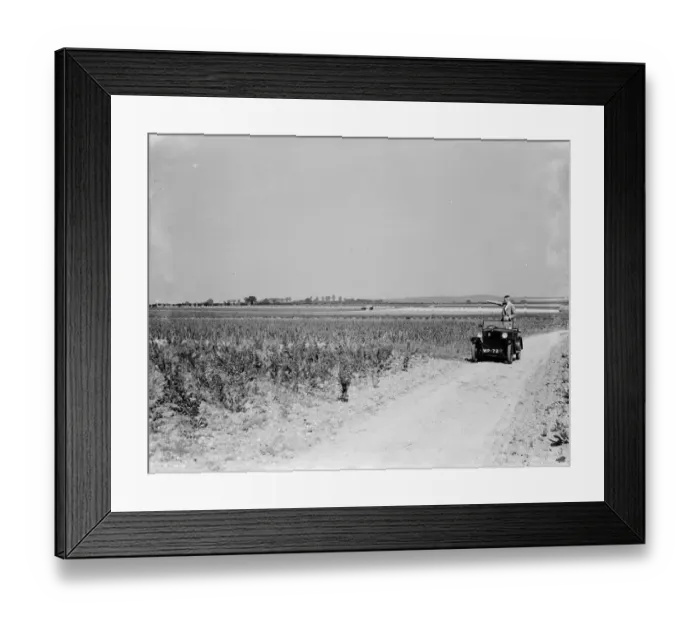 Framed Print : A man stands in his open top car, taking in the countryside scenery Framed Print : A man stands in his open top car, taking in the countryside scenery