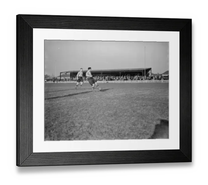 Framed Print : Dartford football club versus Guilford football club. A player plays the ball Framed Print : Dartford football club versus Guilford football club. A player plays the ball