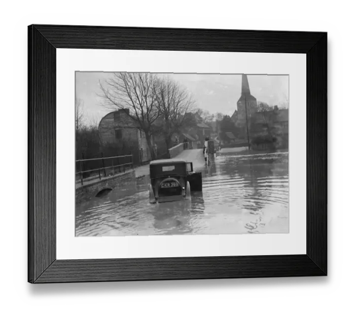 Framed Print : Flooding in Eynsford, Kent. Motorist tries to navigate through the flooded street Framed Print : Flooding in Eynsford, Kent. Motorist tries to navigate through the flooded street