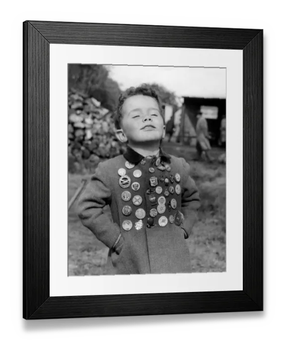Framed Print : Kent. Timothy Elliott aged 3 years proudly displays his collection of badges. 1955 Framed Print : Kent. Timothy Elliott aged 3 years proudly displays his collection of badges. 1955