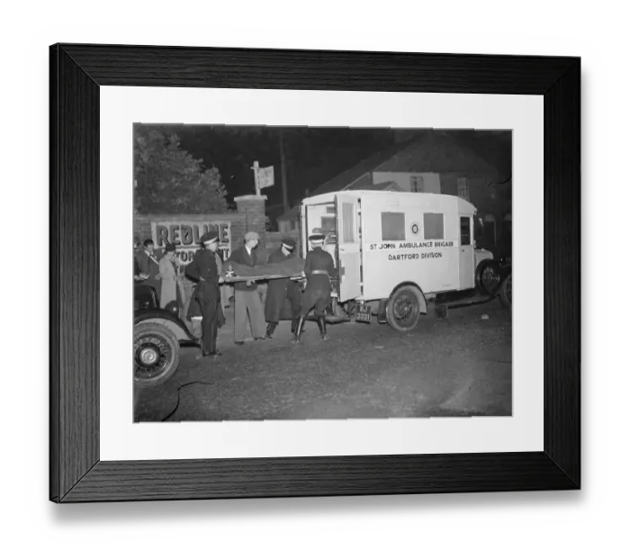Framed Print : A blackout ambulance receiving a casualty in Dartford, Kent. 1939 Framed Print : A blackout ambulance receiving a casualty in Dartford, Kent. 1939