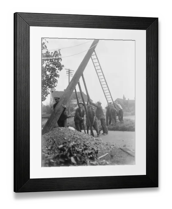 Framed Print : workers use ladders and poles erect an electric pylon next to a road in Trottiscliffe Framed Print : workers use ladders and poles erect an electric pylon next to a road in Trottiscliffe