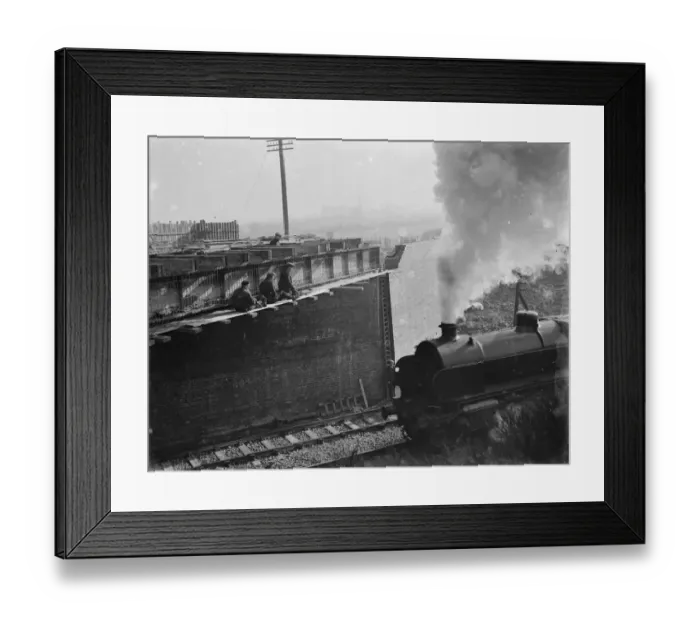 Framed Print : Steam engine passing by the building work being carried out for the widening of Framed Print : Steam engine passing by the building work being carried out for the widening of