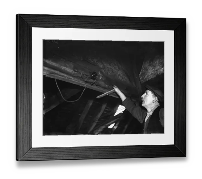Framed Print : A farmer points out an electric switch on the beams in the old forge Framed Print : A farmer points out an electric switch on the beams in the old forge