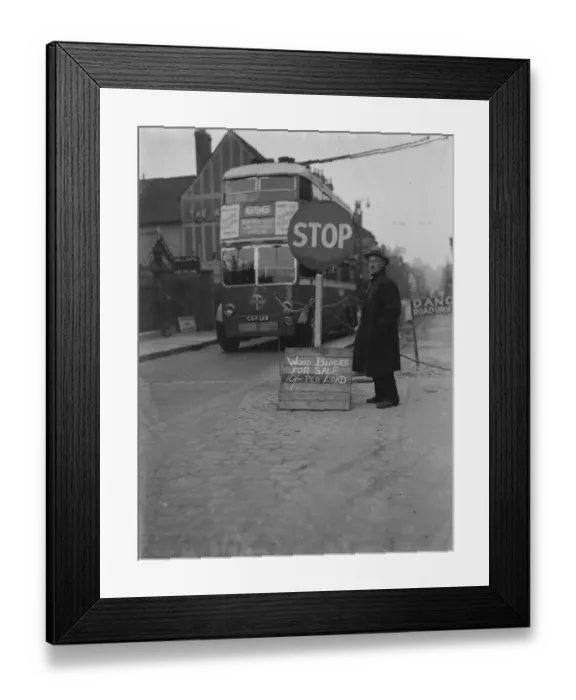 Framed Print : A man with a wood blocks for sale sign on side of the road in Dartford, Kent Framed Print : A man with a wood blocks for sale sign on side of the road in Dartford, Kent