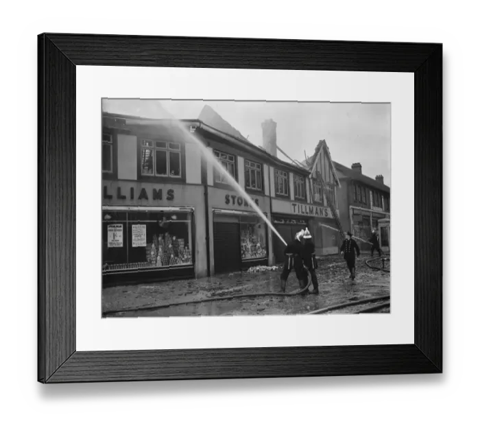Framed Print : Firemen attempt to put out fires in a parade of shops in Welling, Kent Framed Print : Firemen attempt to put out fires in a parade of shops in Welling, Kent