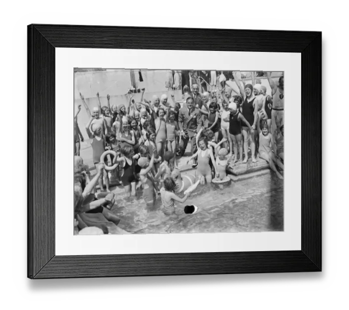 Framed Print : The Swanscombe Baths in Kent. Children cheer as David Behar launches two inflatable Framed Print : The Swanscombe Baths in Kent. Children cheer as David Behar launches two inflatable