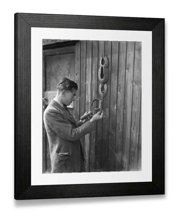 Framed Print : Mr Greenfield examines horseshoes and stirrups found at the excavation site of a Framed Print : Mr Greenfield examines horseshoes and stirrups found at the excavation site of a
