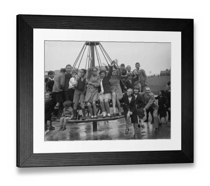 Framed Print : Crayford playground is opened. Children swing on the maypole swing Framed Print : Crayford playground is opened. Children swing on the maypole swing