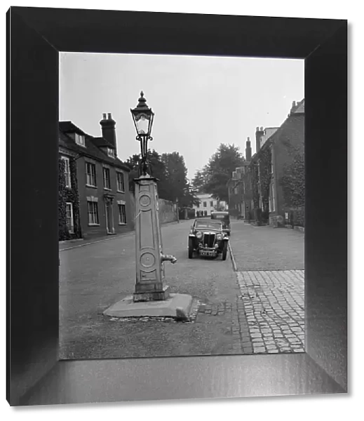 An old water pump used as a street lamp. West Malling. 14 September 1937