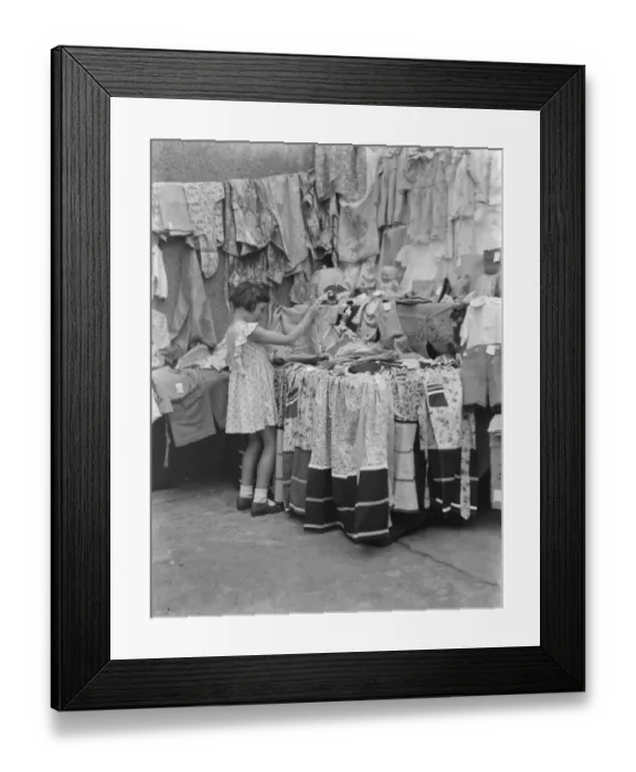 Framed Print : Petts Wood fete in Kent. A little girl at a garment stall. 1937 Framed Print : Petts Wood fete in Kent. A little girl at a garment stall. 1937