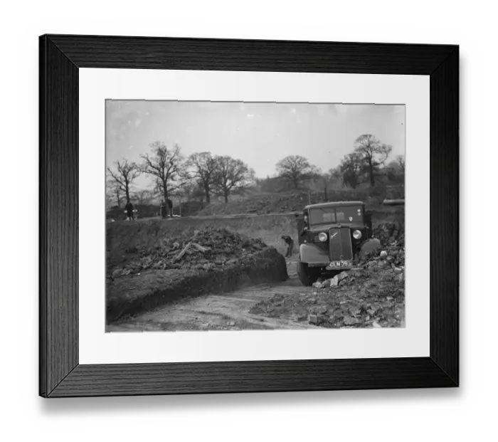 Framed Print : A Bedford truck, full of soil, pulls out of the site where the new swimming pool Framed Print : A Bedford truck, full of soil, pulls out of the site where the new swimming pool