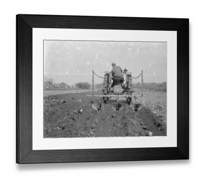 Framed Print : A farmer and his tractor plough a field. 1935 Framed Print : A farmer and his tractor plough a field. 1935