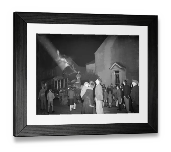 Framed Print : A crowd watching the mobile Army searchlight as it progresses down their street Framed Print : A crowd watching the mobile Army searchlight as it progresses down their street