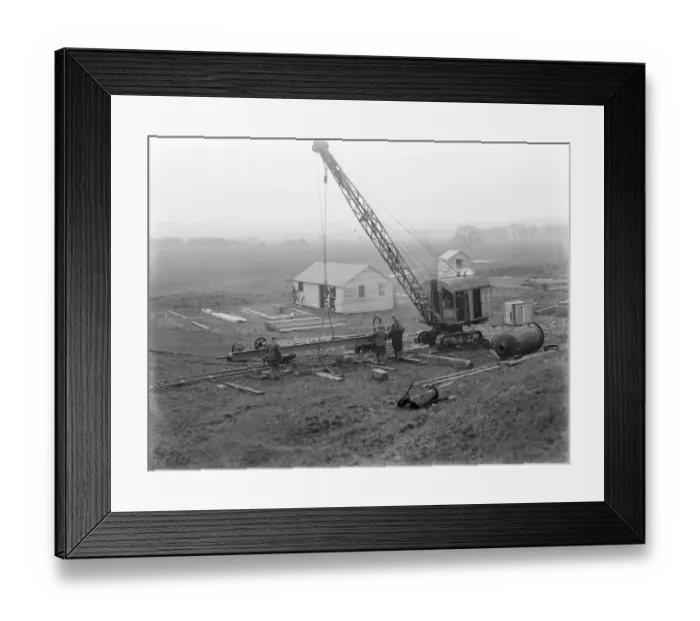 Framed Print : Workmen using a crane for the construction of the Dartford Tunnel. Work begins Framed Print : Workmen using a crane for the construction of the Dartford Tunnel. Work begins