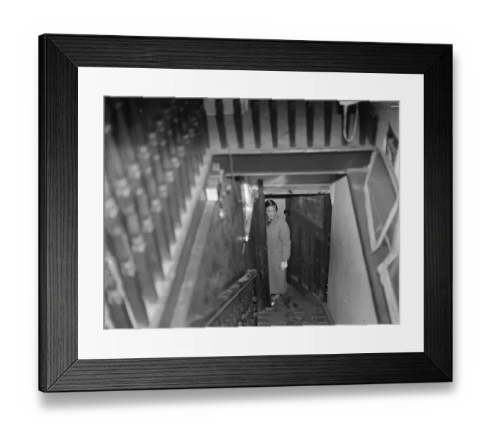 Framed Print : Miss Haken posing from the bottom of the stairs in Sidcup, Kent. 1937