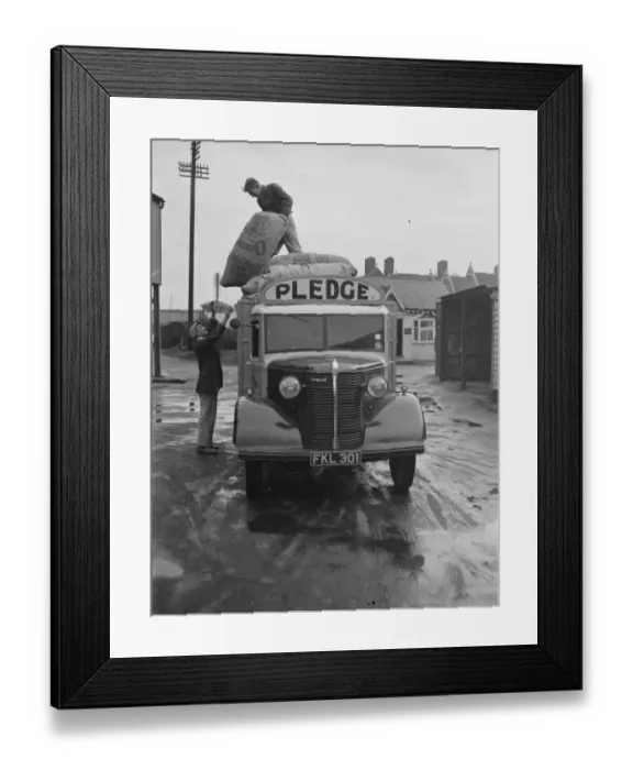 Framed Print : Workers are unloading sacks from a Bedford truck belonging to Pledge & Son Ltd