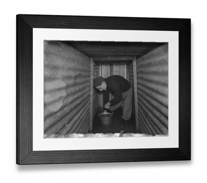 Framed Print : The interior of a flooded dug out in Sidcup, Kent. Mr George Harris attempts Framed Print : The interior of a flooded dug out in Sidcup, Kent. Mr George Harris attempts