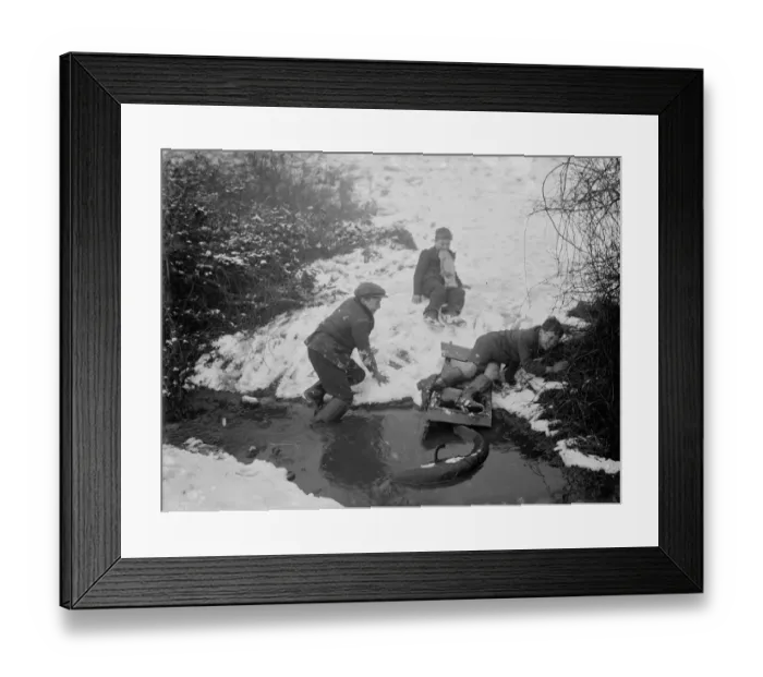 Framed Print : Boys getting out of a stream after crashing into it on their toboggan Framed Print : Boys getting out of a stream after crashing into it on their toboggan