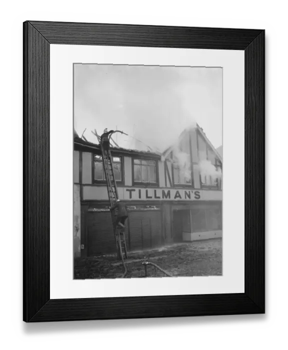 Framed Print : Firemen attempt to put out fires in a parade of shops in Welling, Kent Framed Print : Firemen attempt to put out fires in a parade of shops in Welling, Kent