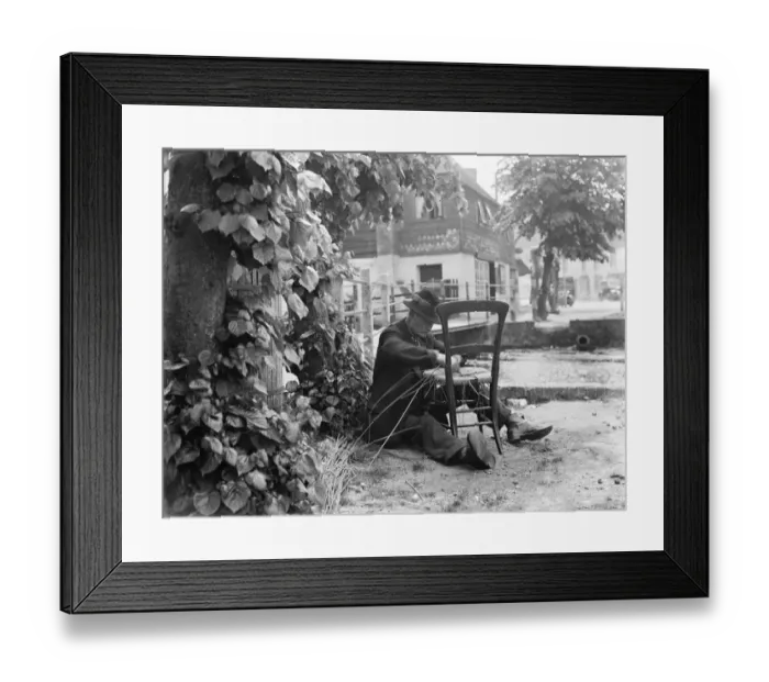 Framed Print : An elderly man fixes the seat of a chair with wicker. 1936 Framed Print : An elderly man fixes the seat of a chair with wicker. 1936