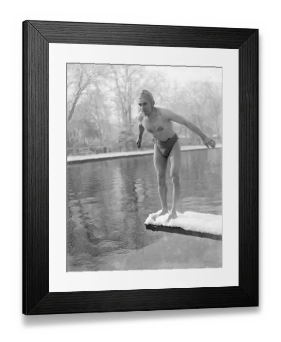 Framed Print : Winter swimming. A man diveing into the cold water. He is standing on a snow-covered Framed Print : Winter swimming. A man diveing into the cold water. He is standing on a snow-covered