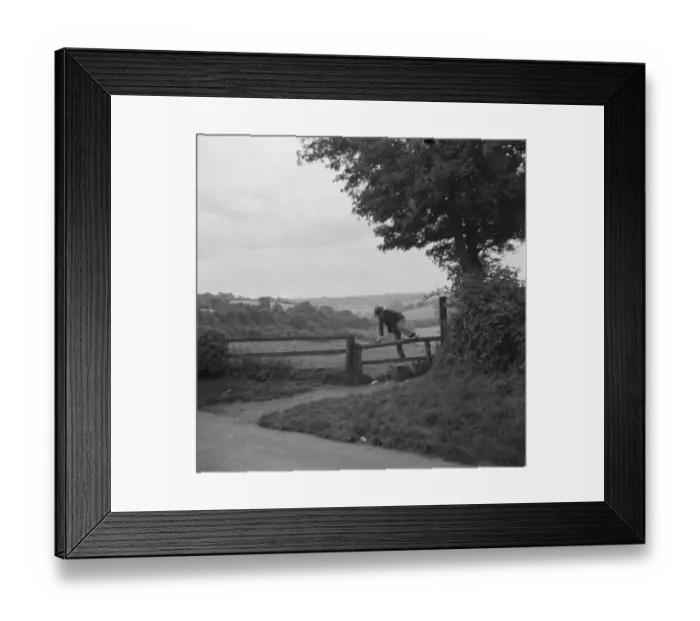 Framed Print : A man crossing a stile in Cudham, Kent. 1936 Framed Print : A man crossing a stile in Cudham, Kent. 1936