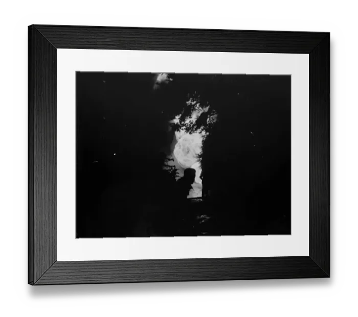 Framed Print : The silhouetted figure of a man can be seen against the flames from the fire Framed Print : The silhouetted figure of a man can be seen against the flames from the fire