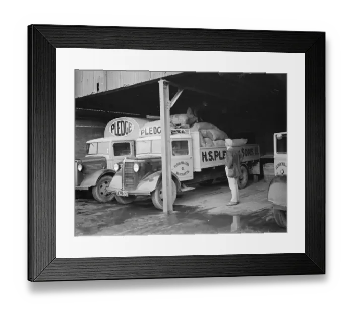 Framed Print : Bedford trucks belonging to Pledge & Son Ltd, the milling company, are being loaded Framed Print : Bedford trucks belonging to Pledge & Son Ltd, the milling company, are being loaded