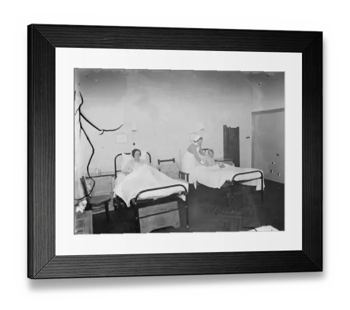 Framed Print : The Sidcup Cottage Hospital in Kent. A nurse tends to a patient in the womens ward Framed Print : The Sidcup Cottage Hospital in Kent. A nurse tends to a patient in the womens ward