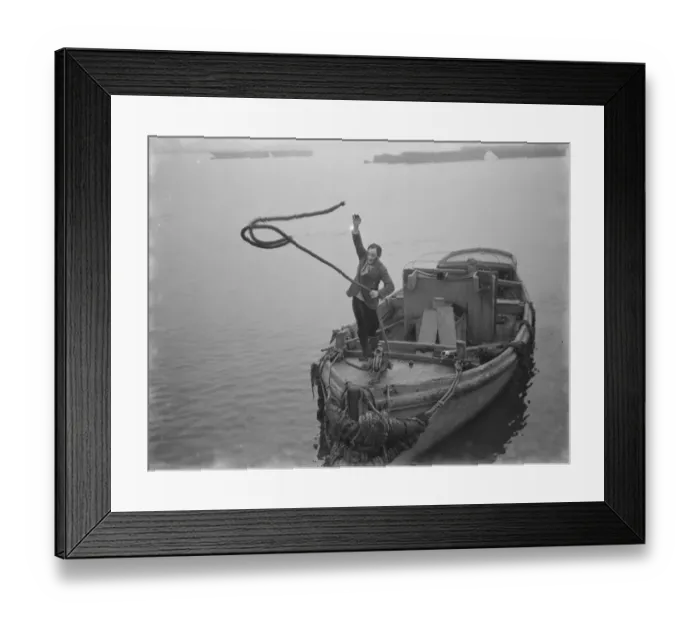 Framed Print : Mr Frank Clark MP tossing the lines to the quay side to tie up the boat. 1936