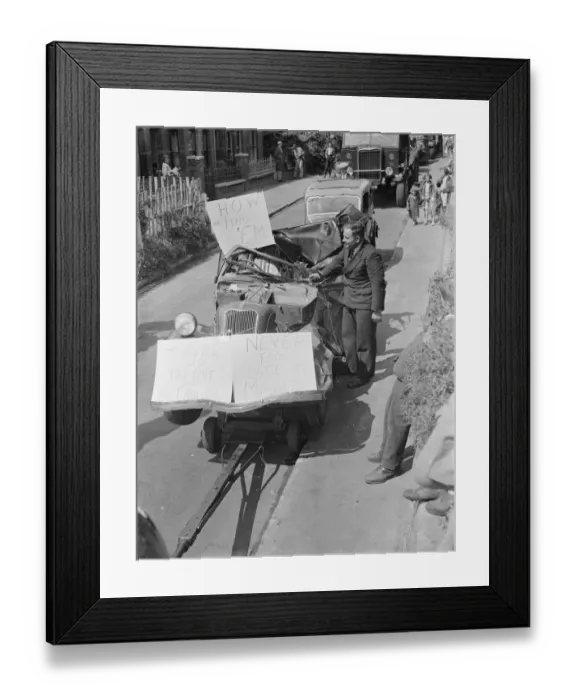 Framed Print : The Gravesend Carnival procession in Kent. A crashed car on a toe bar in Framed Print : The Gravesend Carnival procession in Kent. A crashed car on a toe bar in