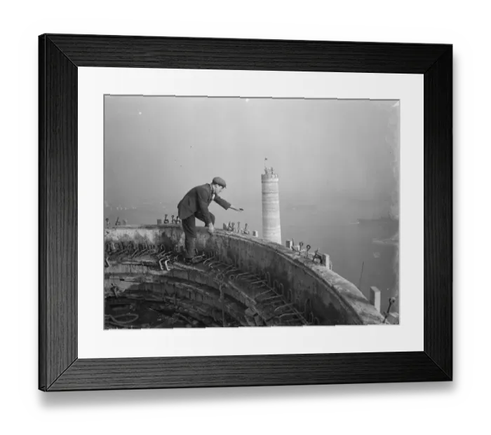 Framed Print : A workman waves down from one of the chimneys of the new coal electric power station