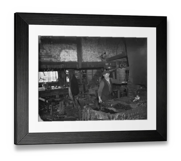 Framed Print : The blacksmith at work in the Westerham Forge. 1935