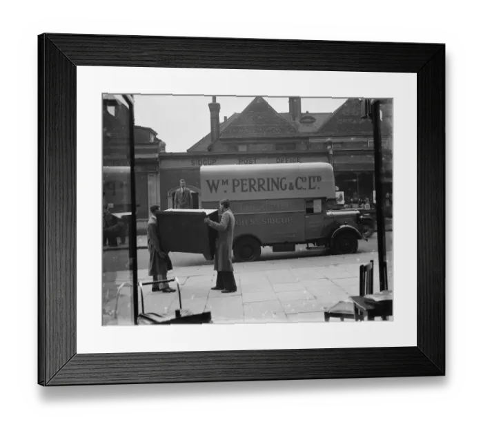 Framed Print : A Bedford truck belonging to W Perring and Co Ltd, the house furnishers. Workers