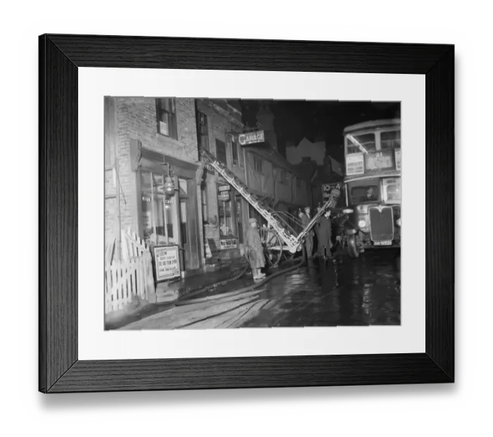 Framed Print : The fire brigade dealing with a fire at a Foots Cray shop in Kent A ladder up Framed Print : The fire brigade dealing with a fire at a Foots Cray shop in Kent A ladder up