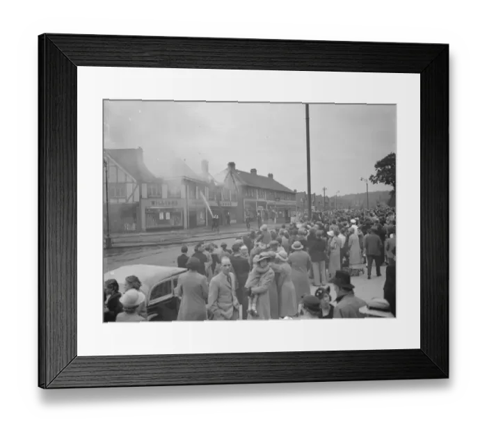 Framed Print : Crowds watch as firemen attempt to put out fires in a parade of shops in Welling, Kent Framed Print : Crowds watch as firemen attempt to put out fires in a parade of shops in Welling, Kent