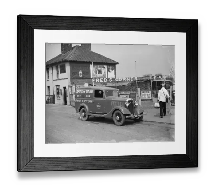 Framed Print : A Express Dairy Delivery Bedford van from London, makes a delivery to Freds Corner