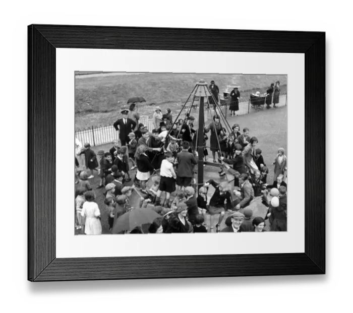 Framed Print : The childrens playground roundabout, a popular place for children after school
