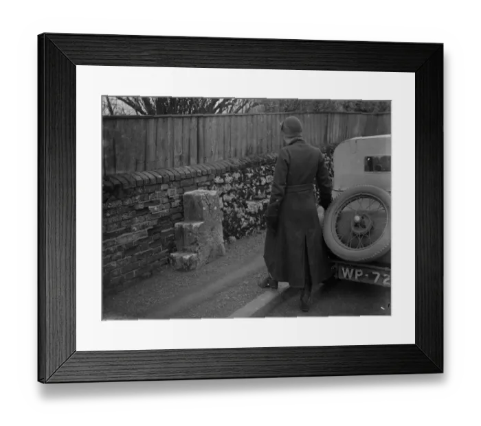 Framed Print : Old and new. A woman motorist looks at mounting blocks for horse riders at the roadside Framed Print : Old and new. A woman motorist looks at mounting blocks for horse riders at the roadside
