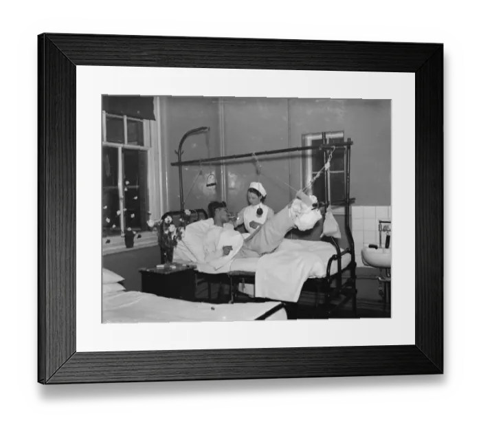 Framed Print : Christmas at the County Hospital in Dartford, Kent. A nurse is helping a patient smoke Framed Print : Christmas at the County Hospital in Dartford, Kent. A nurse is helping a patient smoke