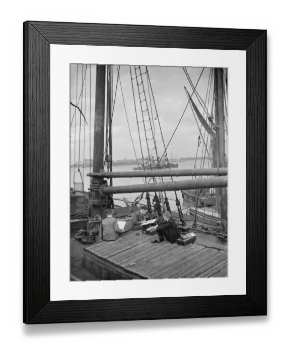 Framed Print : Pupils from the art school sit on the deck of a Thames Barge drawing pictures in Framed Print : Pupils from the art school sit on the deck of a Thames Barge drawing pictures in