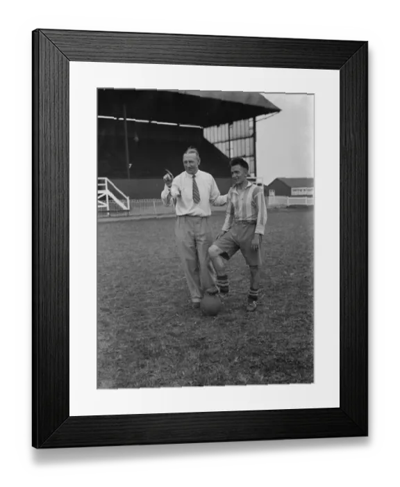Framed Print : Footballers at Dartford. A manager talks tactics to one of his players