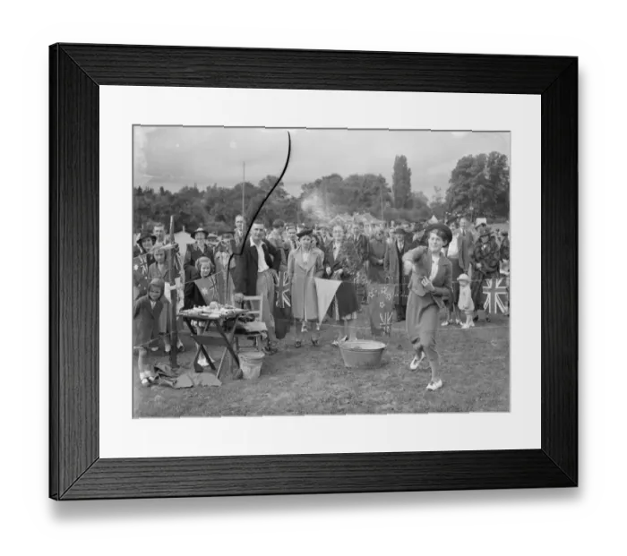 Framed Print : The Chelsfield fete in Kent. A women takes part in one of the side shows