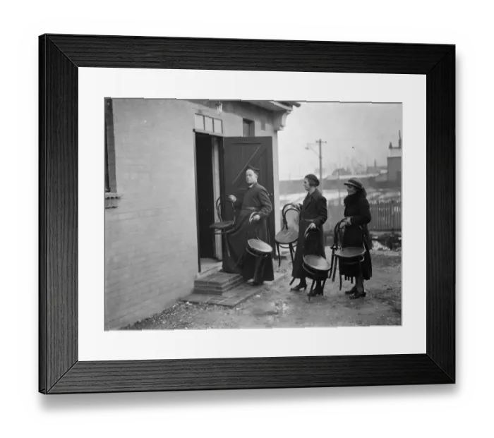 Framed Print : The Reverend M Cox moving chairs with some of his parishioners in Swanscombe, Kent Framed Print : The Reverend M Cox moving chairs with some of his parishioners in Swanscombe, Kent